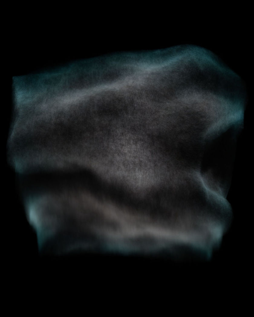 A wall of pure black spreading across a dim frame and consuming the last sliver of light on a true black ground