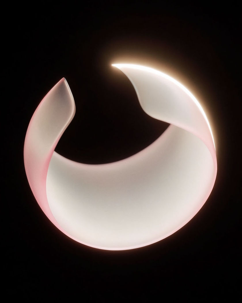 A flat sheet of glowing translucent material caught mid-curl on a black ground